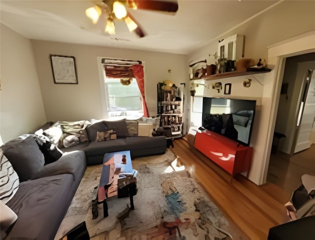 living room with ceiling fan and wood finished floors