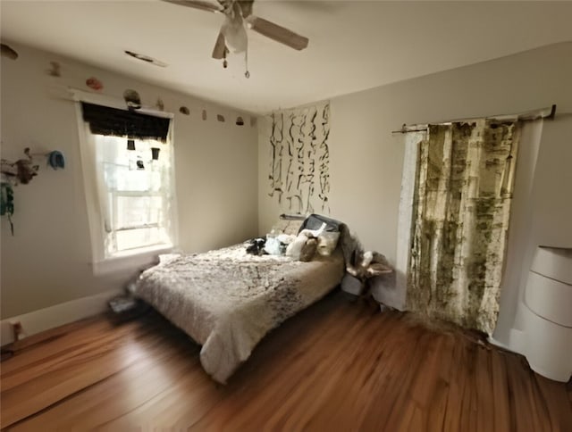 bedroom featuring wood finished floors and a ceiling fan