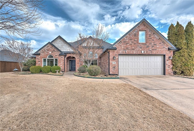 view of front of home featuring a garage, concrete driveway, brick siding, and fence