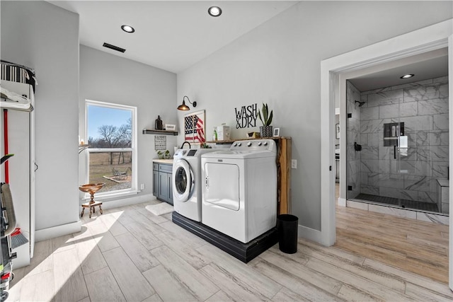 washroom featuring recessed lighting, baseboards, light wood finished floors, and washing machine and clothes dryer