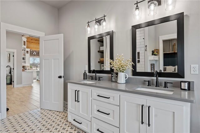 bathroom with a sink and double vanity