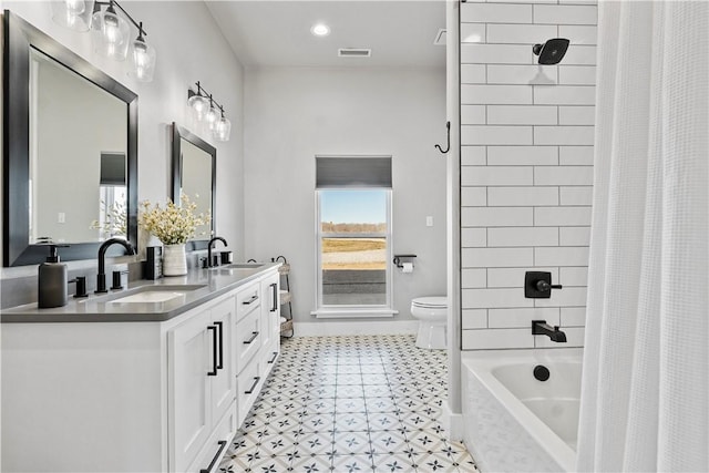 bathroom with toilet, shower / bath combination with curtain, double vanity, and a sink