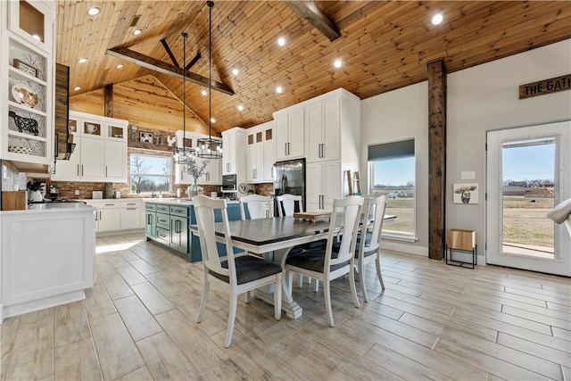 dining space with high vaulted ceiling, wood ceiling, and wood tiled floor