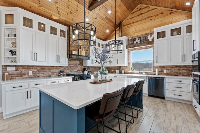 kitchen featuring light wood-type flooring, a center island, wooden ceiling, and dishwasher