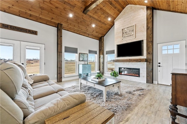 living room featuring a fireplace, wood ceiling, wood finished floors, high vaulted ceiling, and baseboards