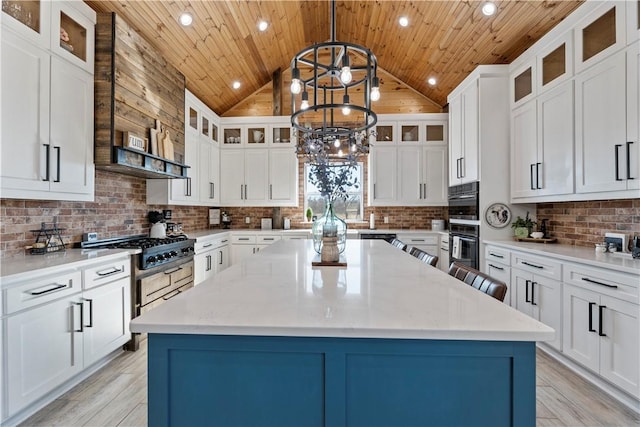 kitchen with a center island, a notable chandelier, lofted ceiling, decorative backsplash, and wooden ceiling