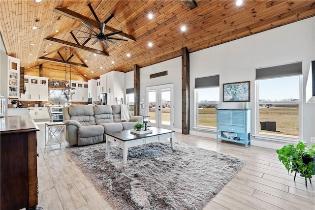 living area with a ceiling fan, wooden ceiling, light wood-style flooring, french doors, and high vaulted ceiling