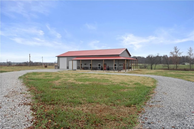 view of pole building with a yard