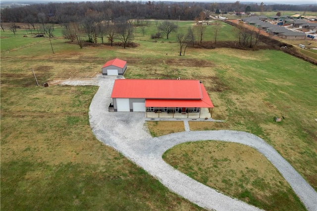 entry to storm shelter featuring an outbuilding, a rural view, and an outdoor structure