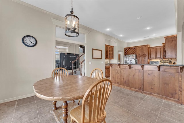 115 NE Lake Forest Ln, Bentonville, AR 72712 - dining area featuring light tile patterned floors, baseboards, and crown molding