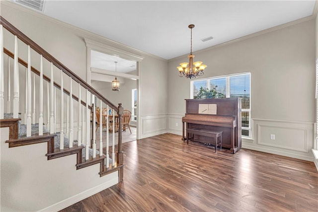 115 NE Lake Forest Ln, Bentonville, AR 72712 - foyer featuring stairway, visible vents, a notable chandelier, and wood finished floors
