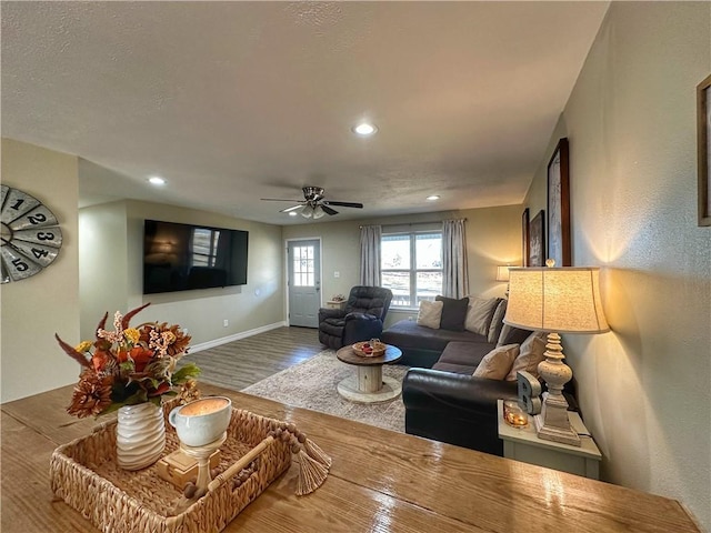 living room featuring a ceiling fan, baseboards, wood finished floors, and recessed lighting