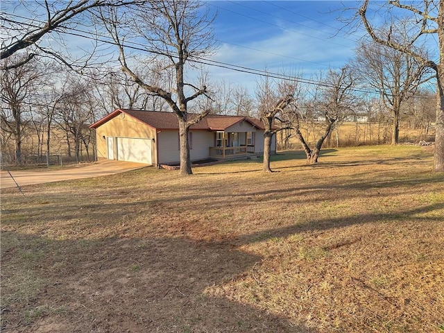 view of front of home with concrete driveway, a front lawn, and an attached garage