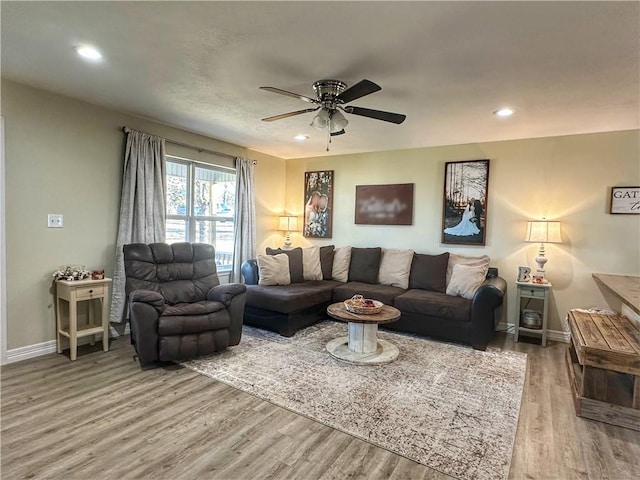 living area featuring recessed lighting, wood finished floors, and baseboards