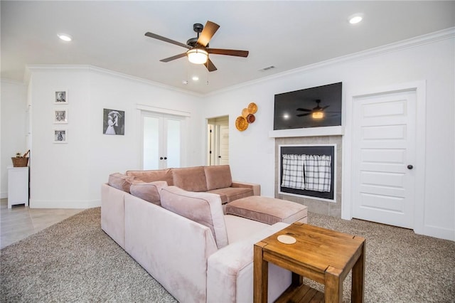 living room with french doors, crown molding, a fireplace, recessed lighting, and visible vents