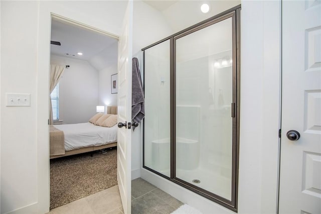 ensuite bathroom with ensuite bathroom, lofted ceiling, tile patterned flooring, recessed lighting, and a shower stall