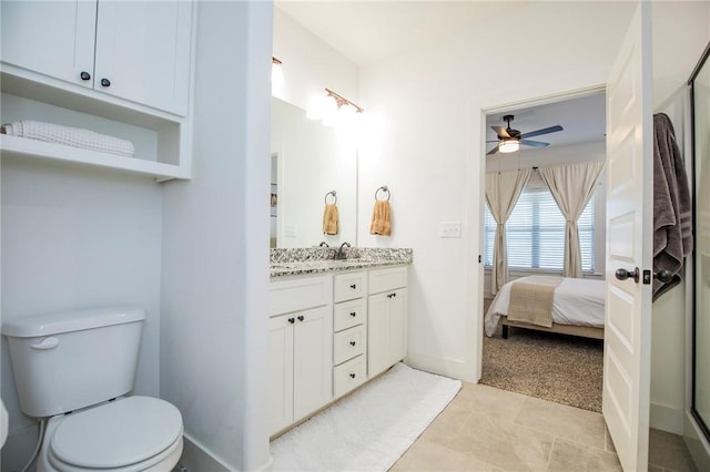 ensuite bathroom featuring baseboards, toilet, ensuite bathroom, an enclosed shower, and vanity