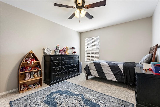 carpeted bedroom featuring ceiling fan and baseboards