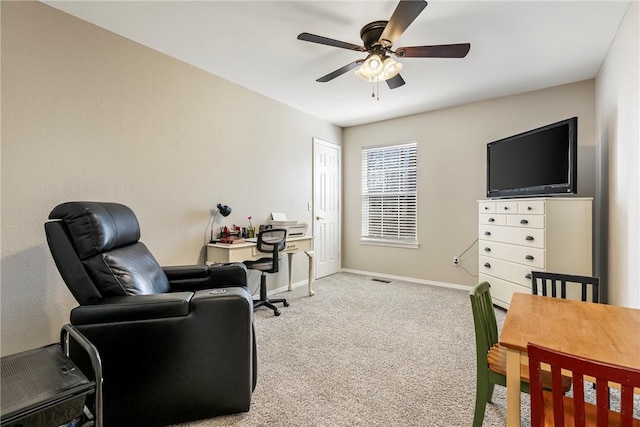 office space with carpet, visible vents, ceiling fan, and baseboards