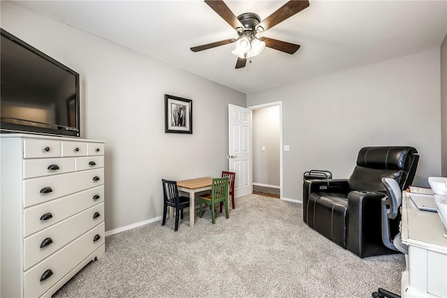 office featuring light carpet, ceiling fan, and baseboards