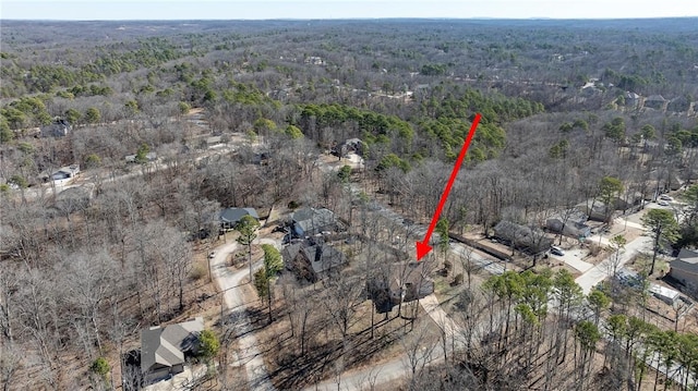 bird's eye view with a wooded view