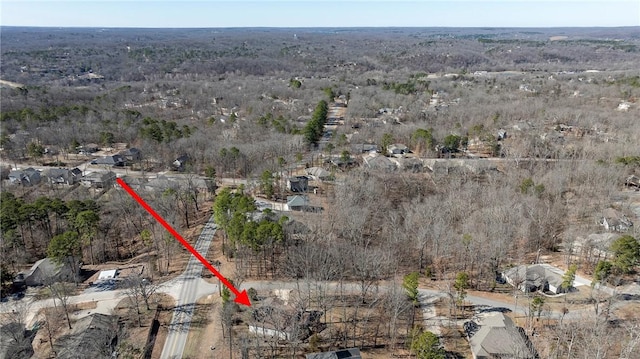 birds eye view of property with a view of trees