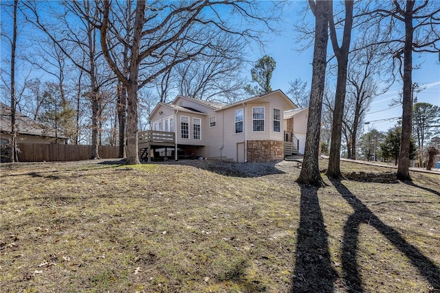 exterior space featuring stone siding and fence