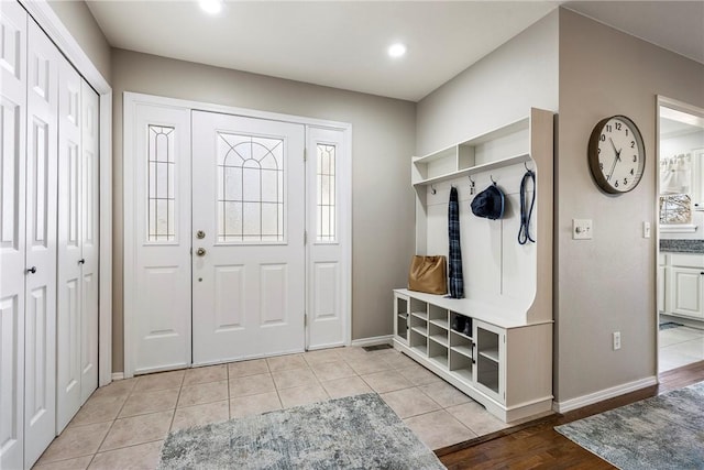 mudroom featuring recessed lighting, baseboards, and light tile patterned floors