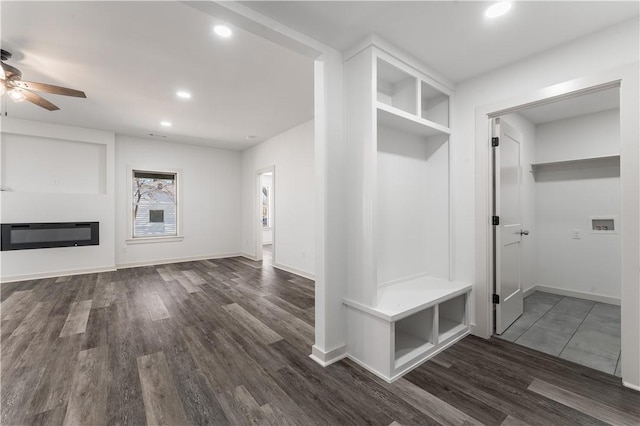 mudroom featuring baseboards, a ceiling fan, a glass covered fireplace, dark wood-style flooring, and recessed lighting