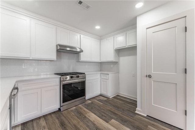 kitchen with under cabinet range hood, white cabinetry, visible vents, appliances with stainless steel finishes, and dark wood-style floors