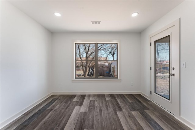 interior space featuring dark wood-style floors, baseboards, visible vents, and recessed lighting