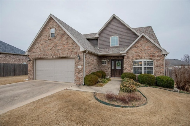 traditional-style home featuring concrete driveway, roof with shingles, an attached garage, fence, and brick siding