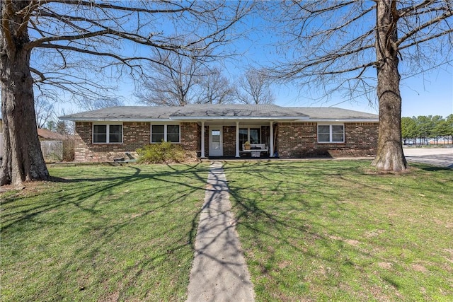 single story home featuring brick siding and a front lawn