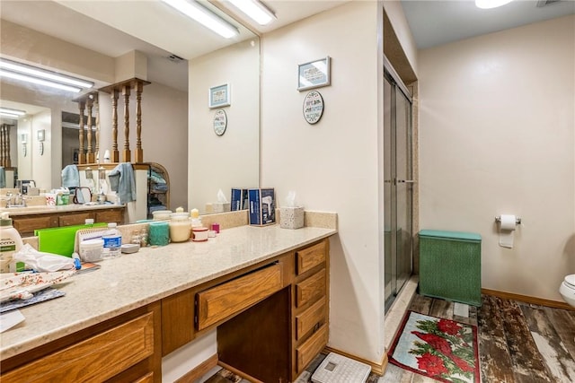 full bathroom with visible vents, toilet, a stall shower, wood finished floors, and vanity