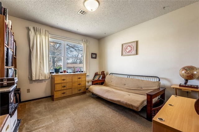 living area featuring visible vents, light colored carpet, a textured ceiling, and baseboards