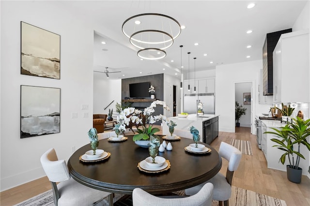 dining area with baseboards, recessed lighting, and light wood-style floors