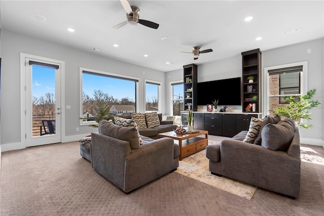 carpeted living area featuring visible vents, baseboards, and recessed lighting