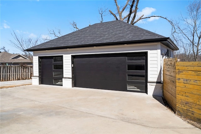 detached garage featuring fence