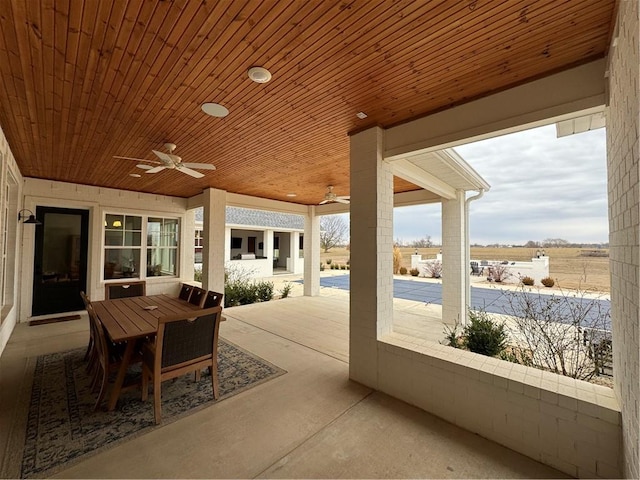 view of patio featuring outdoor dining area and a ceiling fan