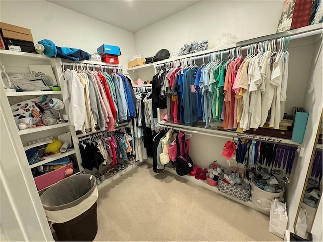 walk in closet featuring carpet flooring