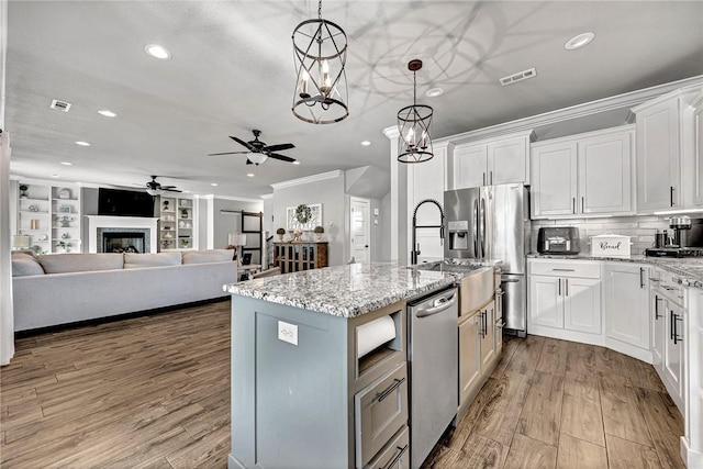 kitchen featuring recessed lighting, ornamental molding, ceiling fan, and appliances with stainless steel finishes