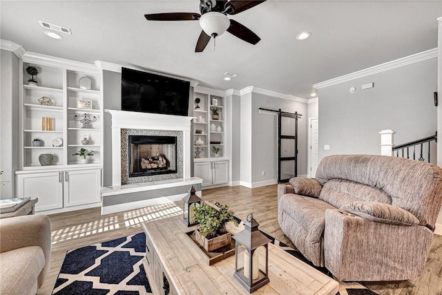 living area with recessed lighting, crown molding, a ceiling fan, visible vents, and baseboards
