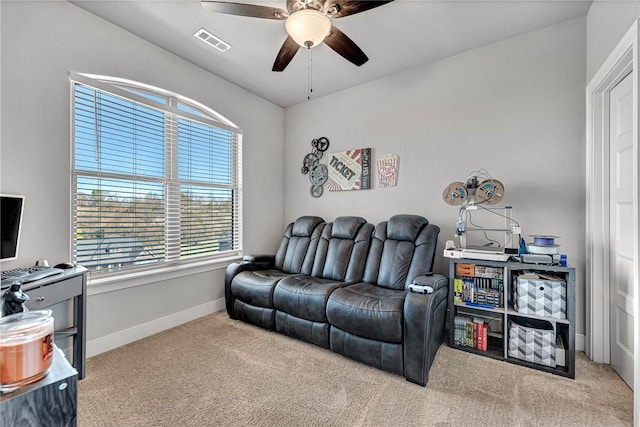 living room featuring ceiling fan, carpet, visible vents, and baseboards