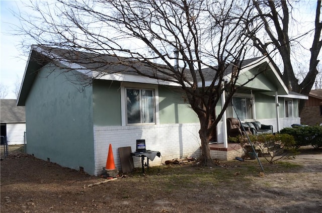 view of front of house with brick siding and stucco siding