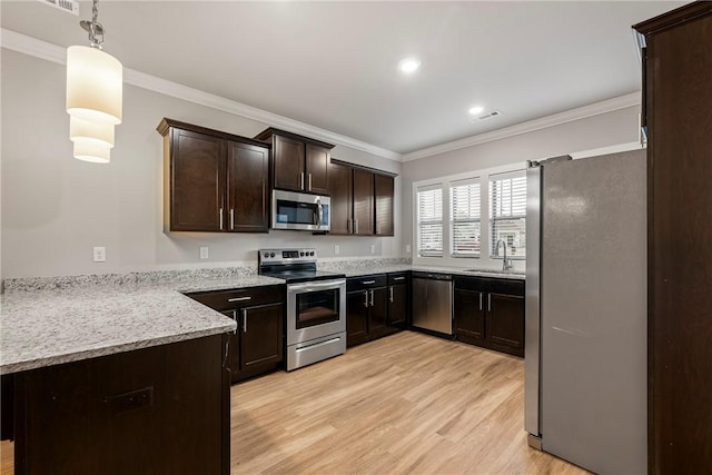 kitchen featuring crown molding, stainless steel appliances, light wood-style floors, a sink, and dark brown cabinetry