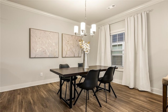 dining room with ornamental molding, wood finished floors, visible vents, and baseboards