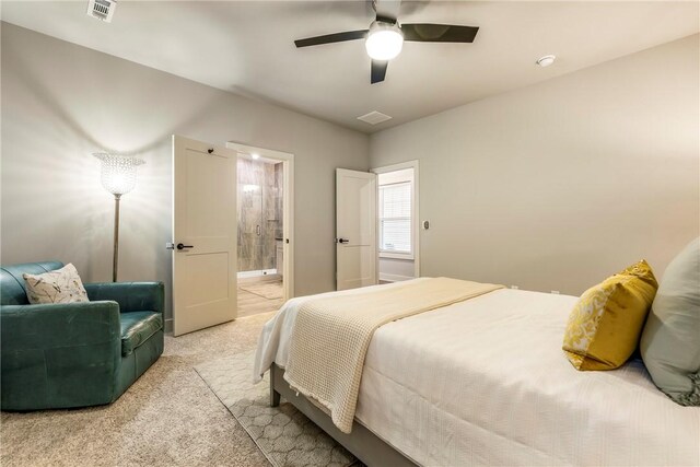 bedroom featuring light carpet, ceiling fan, visible vents, and connected bathroom