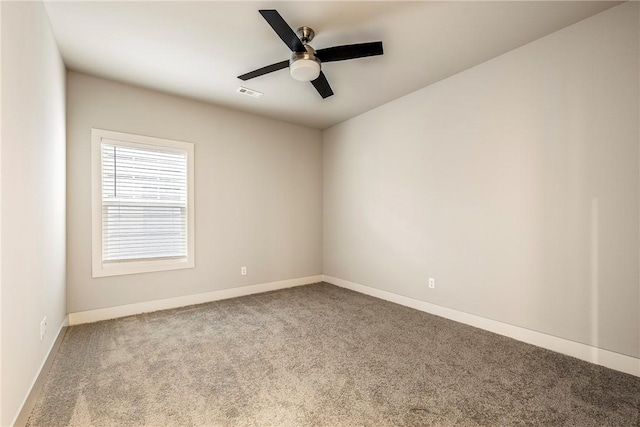 empty room featuring baseboards, carpet, visible vents, and a ceiling fan