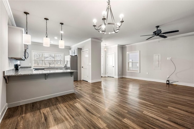 kitchen with stainless steel refrigerator with ice dispenser, crown molding, a peninsula, and dark wood-style floors