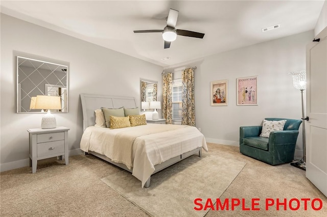 carpeted bedroom with a ceiling fan, visible vents, and baseboards